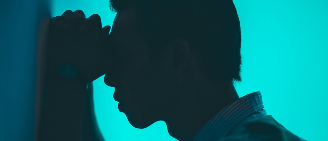 silhouette of man praying frustrated